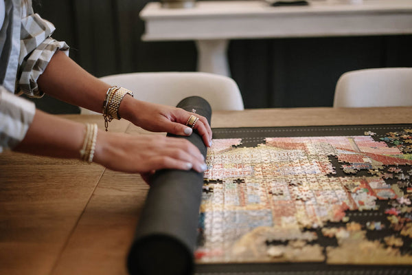 Hands rolling up mat with foam tube