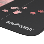 Close-up of smooth polyester top with puzzle pieces for reference